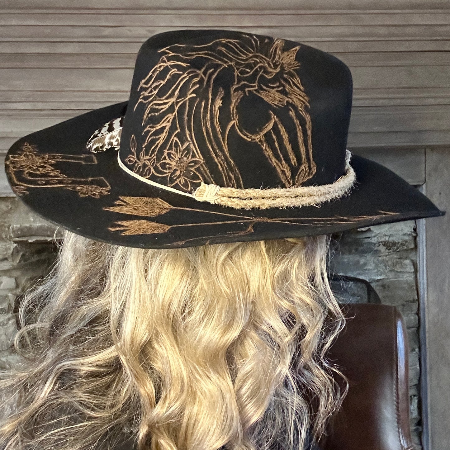 Black cowboy hat with horse design.