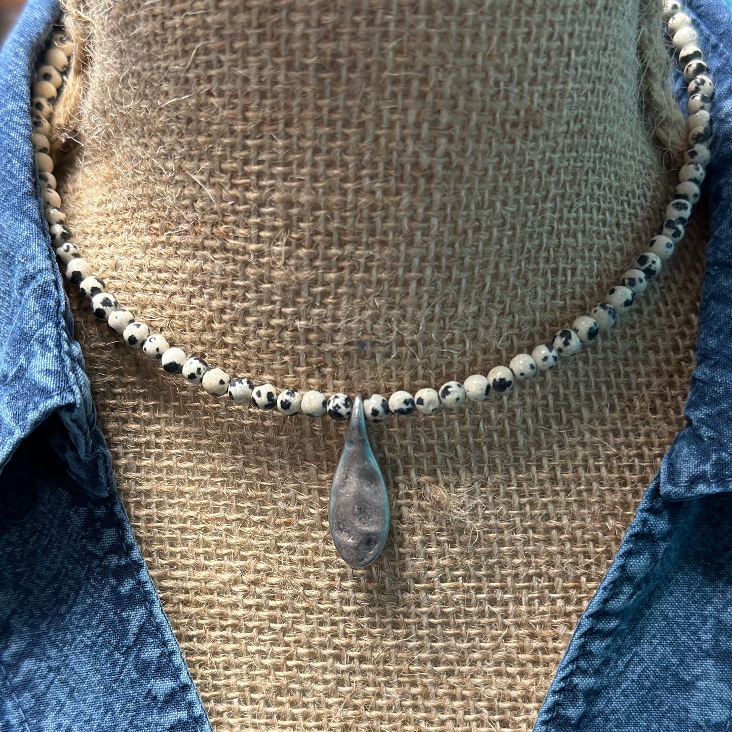 Beaded necklace with silver pendant.
