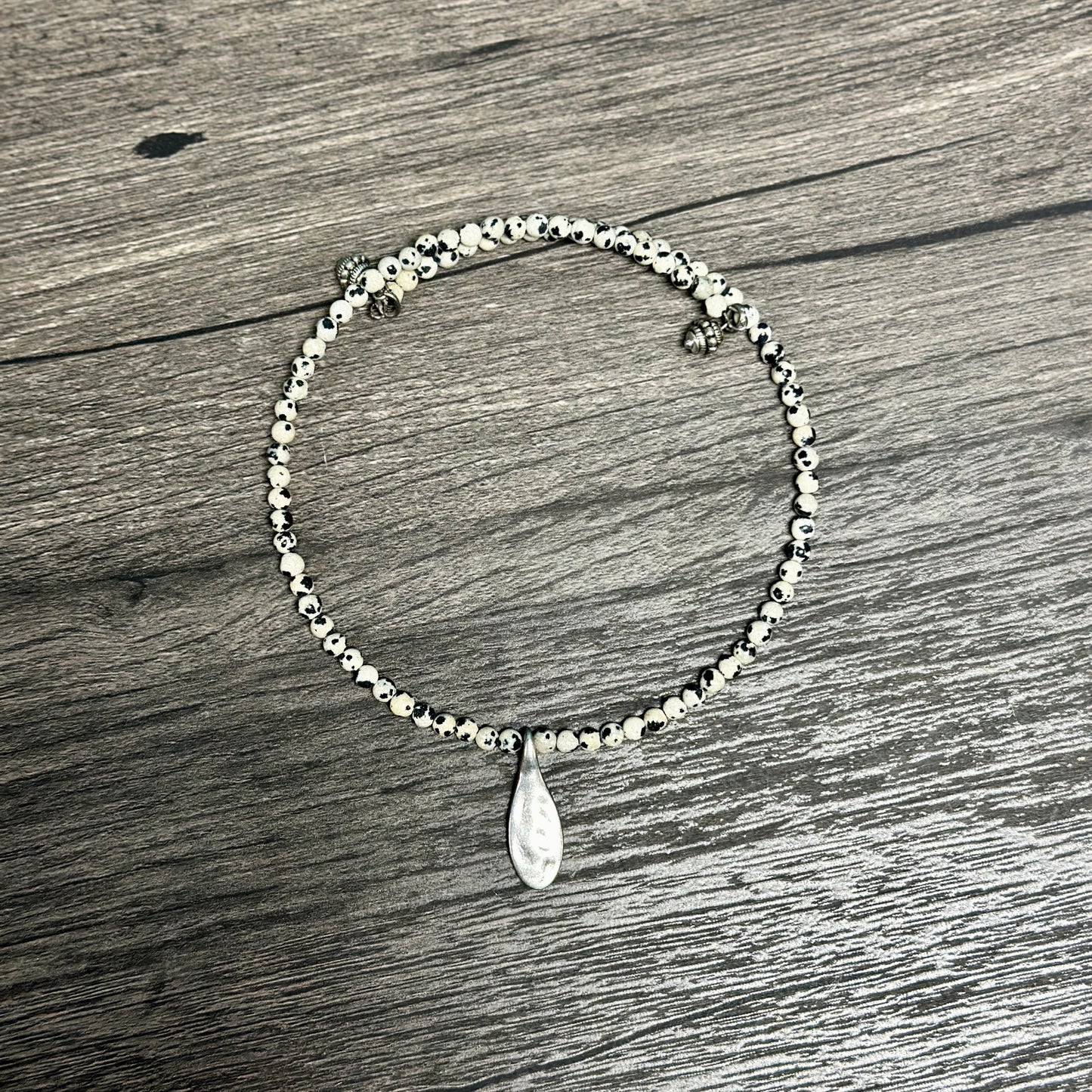 Beaded bracelet with teardrop charm.