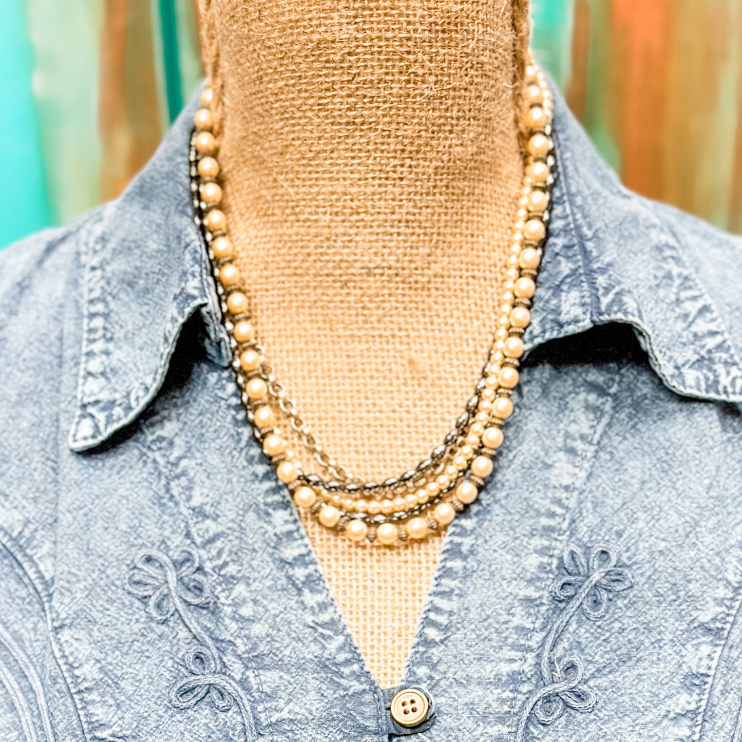 Vintage pearl necklace on denim shirt