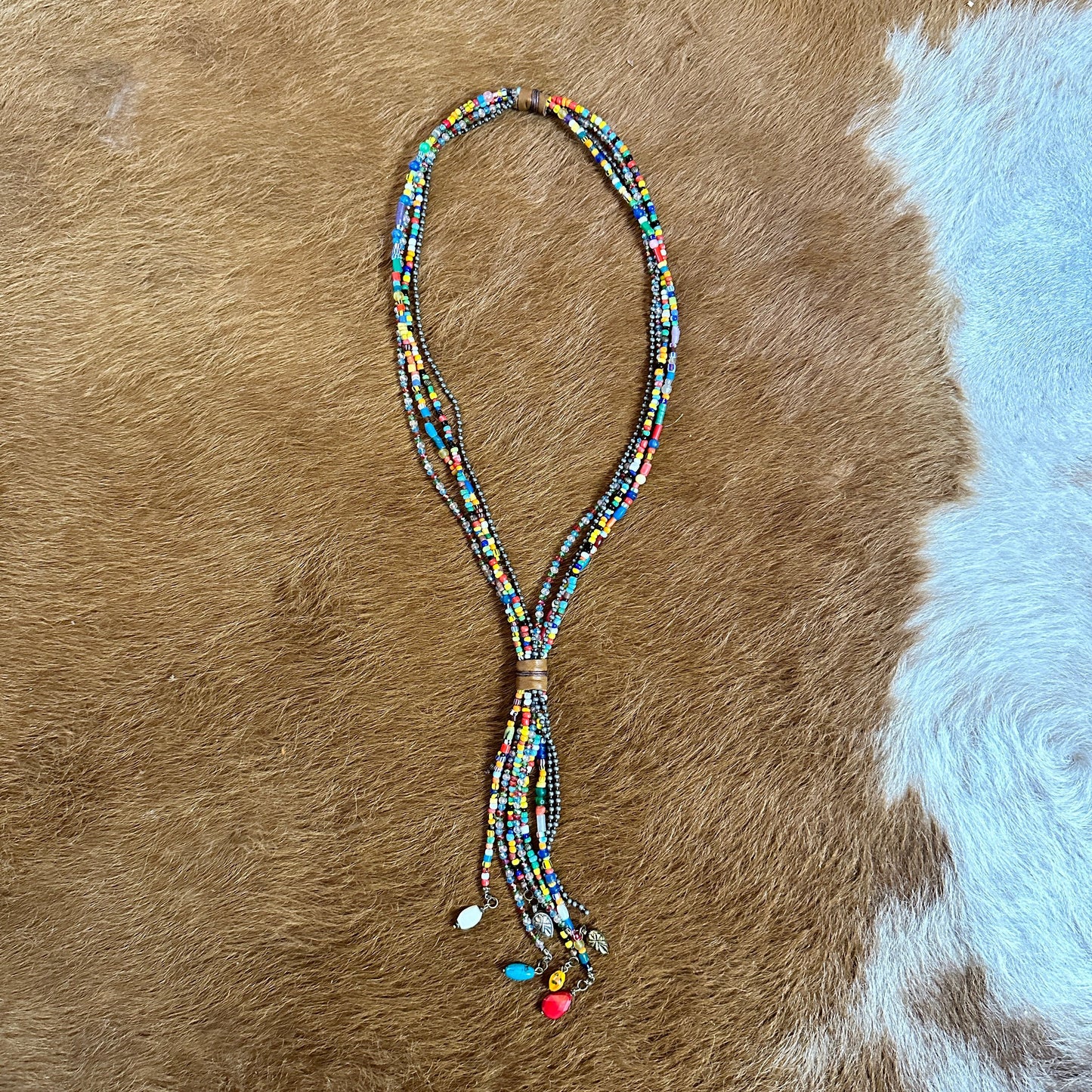 Multi-strand beaded necklace on brown fur.