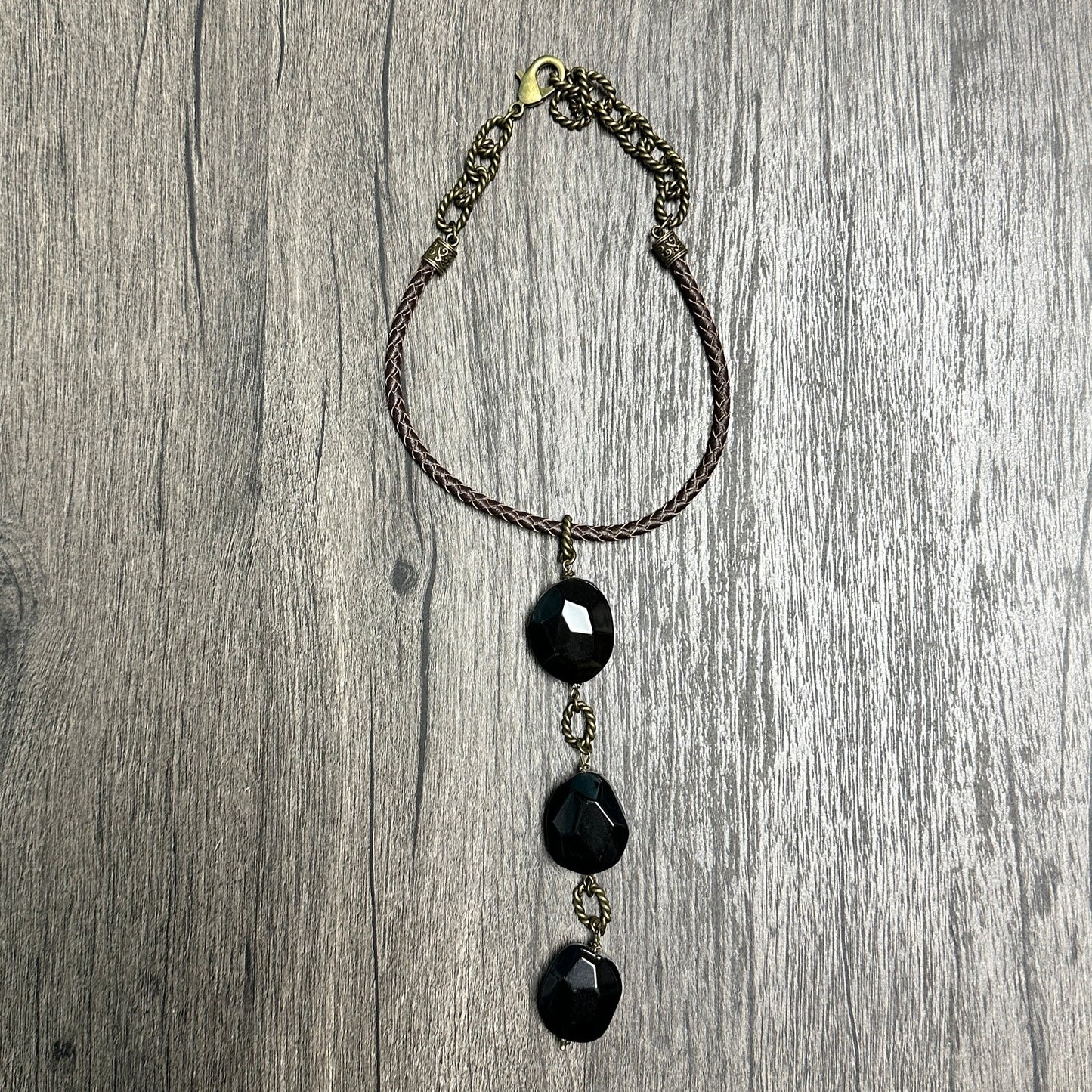 Black beaded necklace on wood