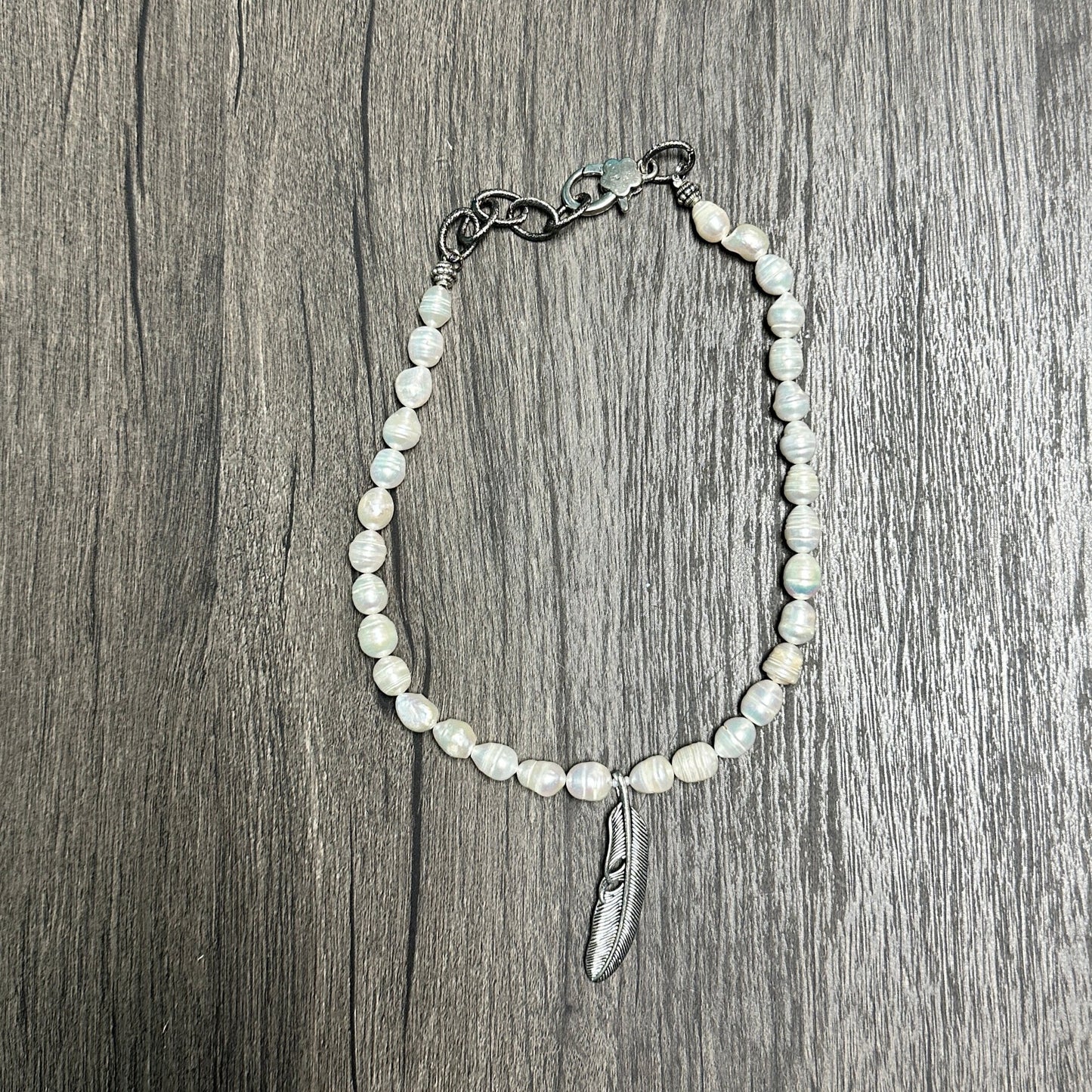 Pearl bracelet with silver charm.