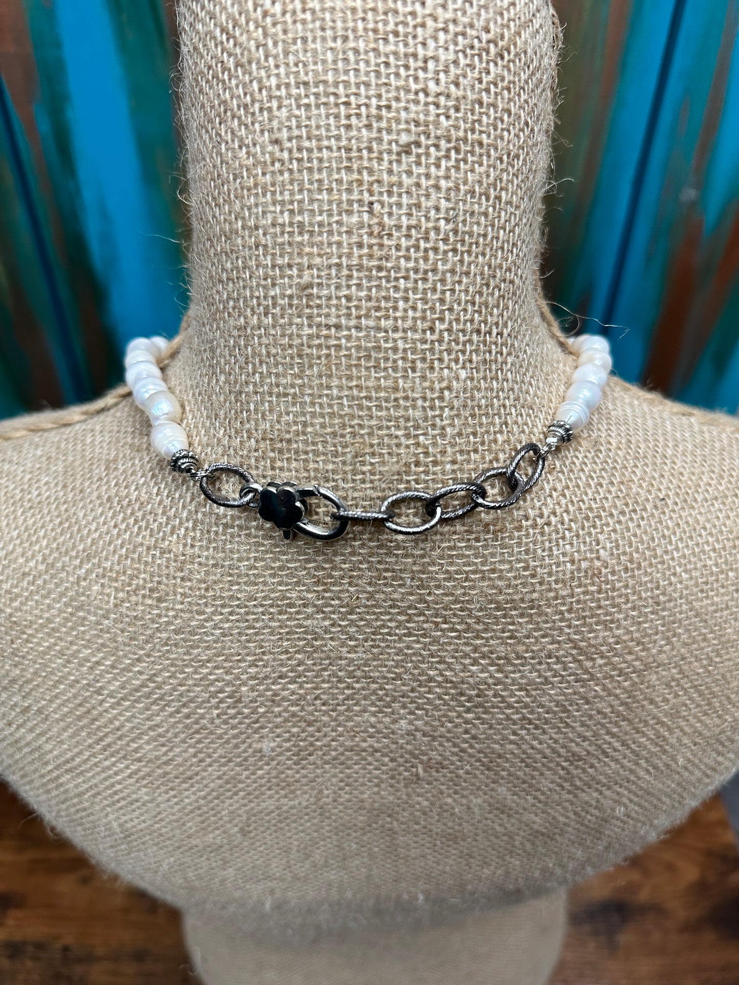 White beaded necklace on a mannequin.