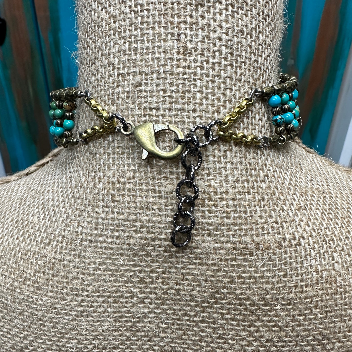 Back of a turquoise beaded choker necklace.