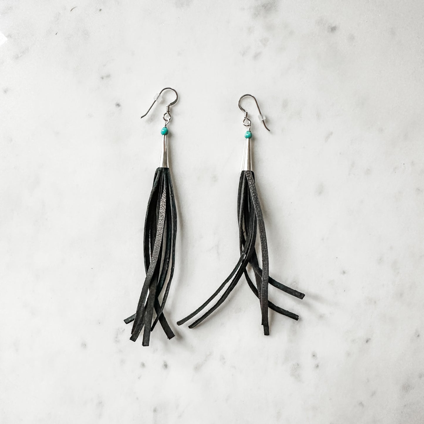 Pair of black leather tassel earrings.