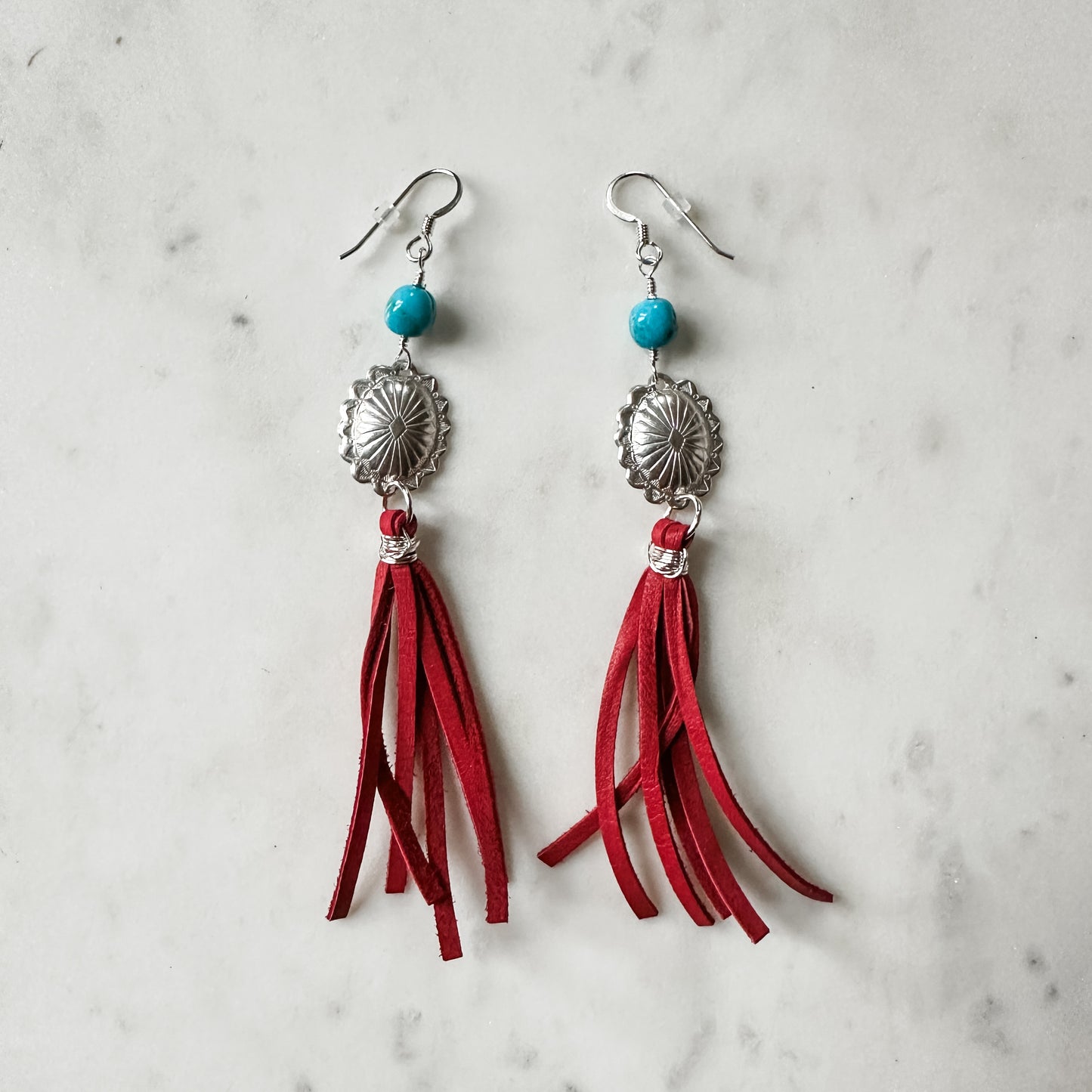 Red tassel earrings with turquoise beads.