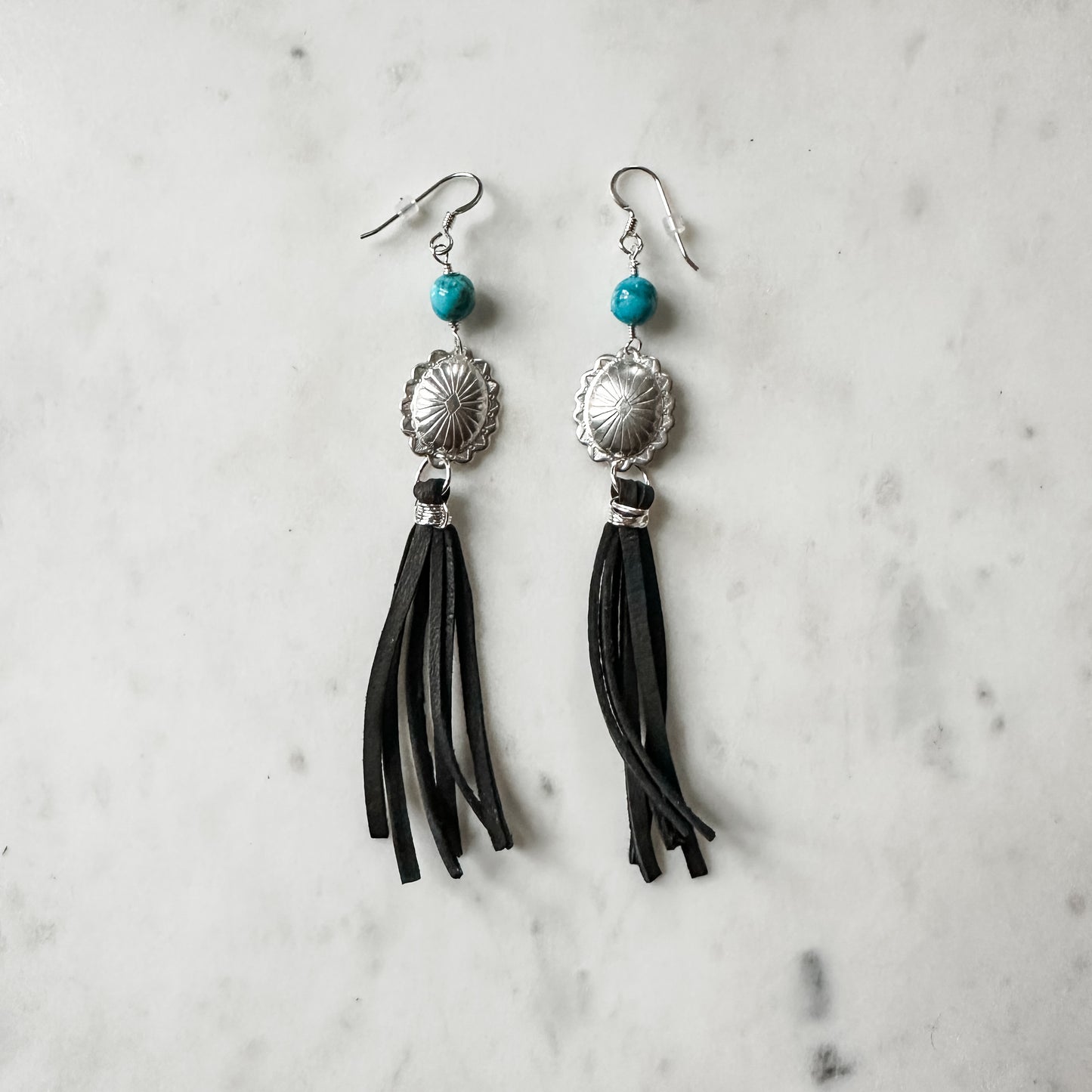 Pair of black tassel earrings with turquoise beads.