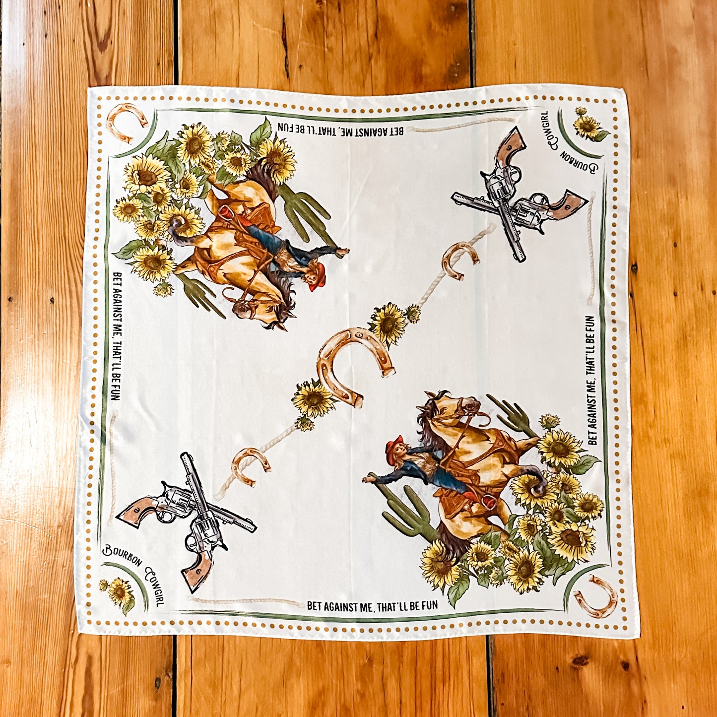 White scarf with cowboy and floral print.