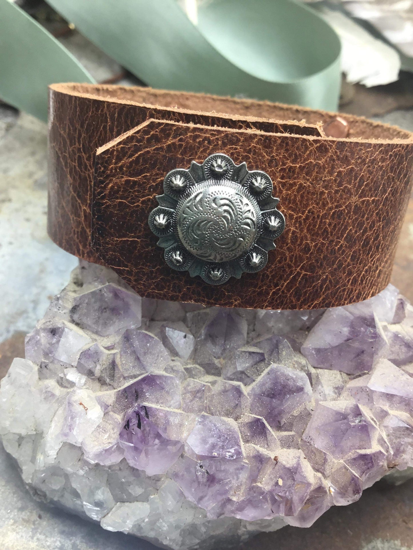 Brown leather cuff bracelet with silver embellishment.