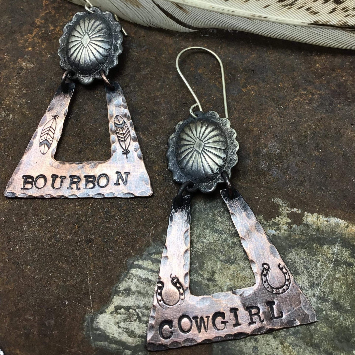 Silver earrings with Bourbon and Cowgirl text.