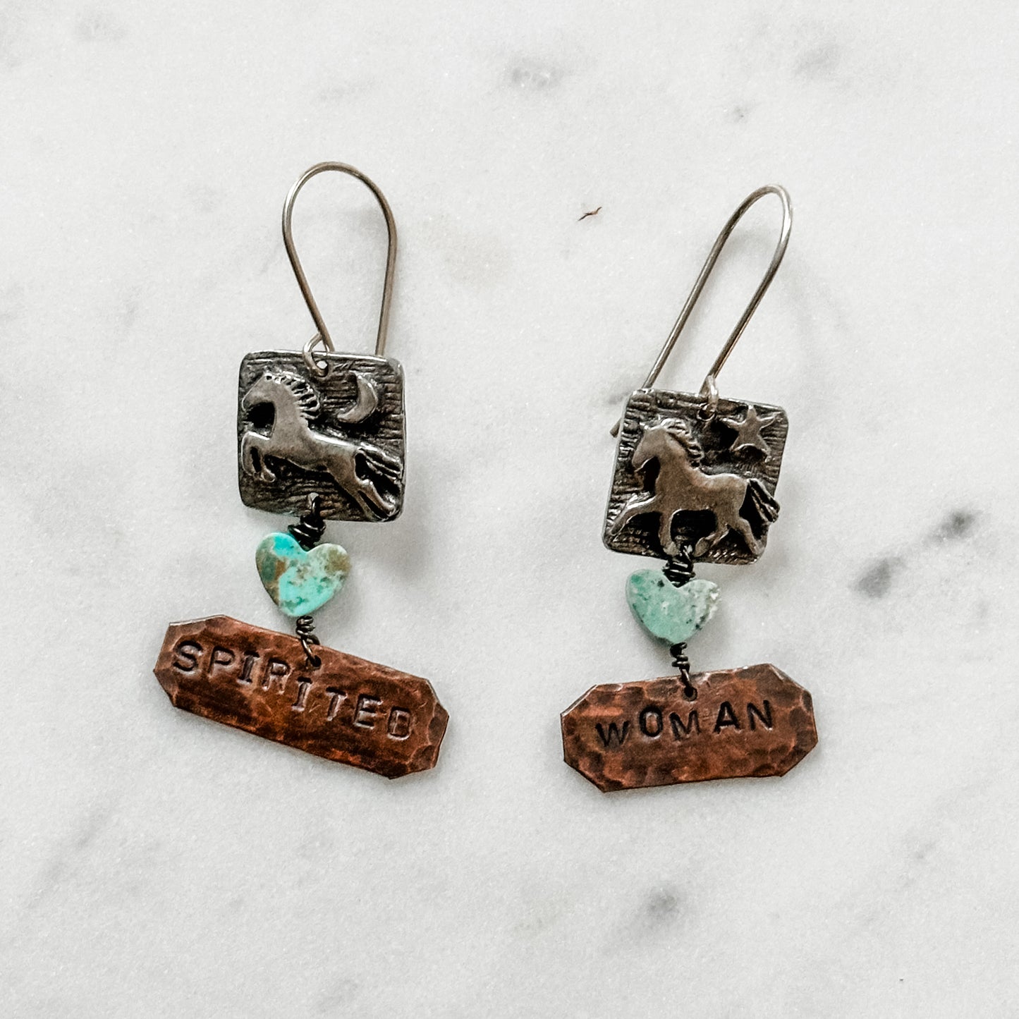 Two horse earrings with charms.