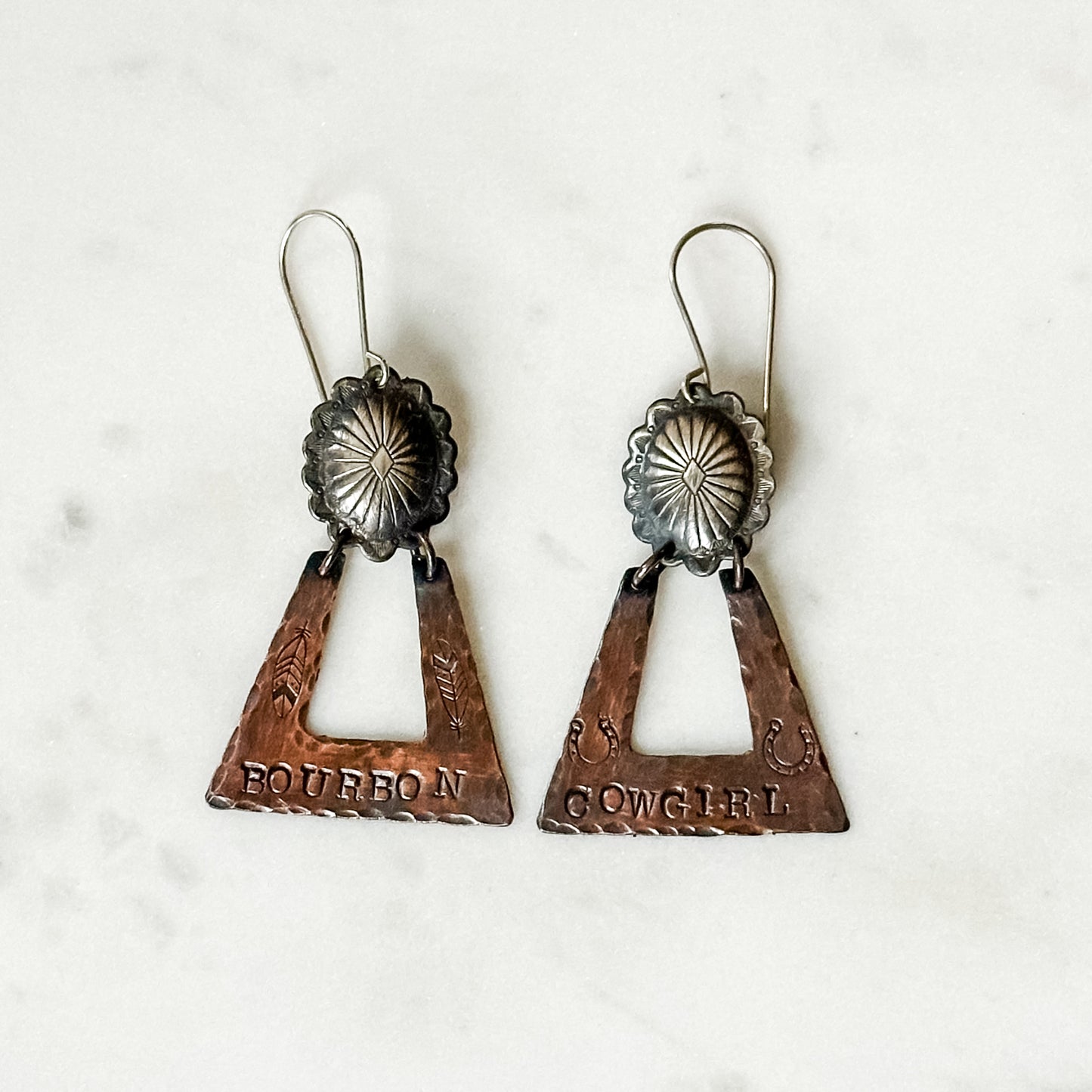 Pair of copper and silver earrings.