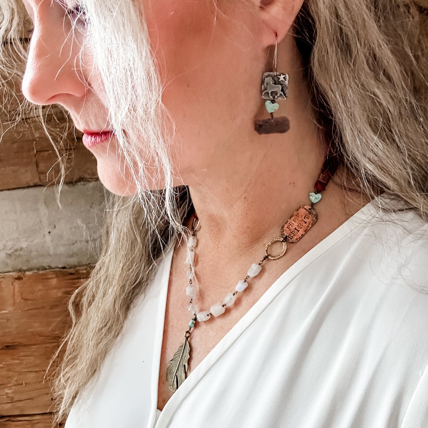 Woman wearing jewelry, side profile.