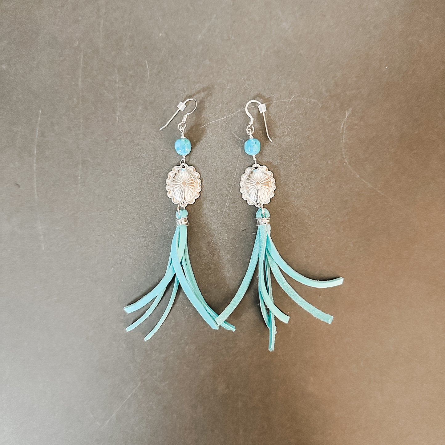 Turquoise tassel earrings.