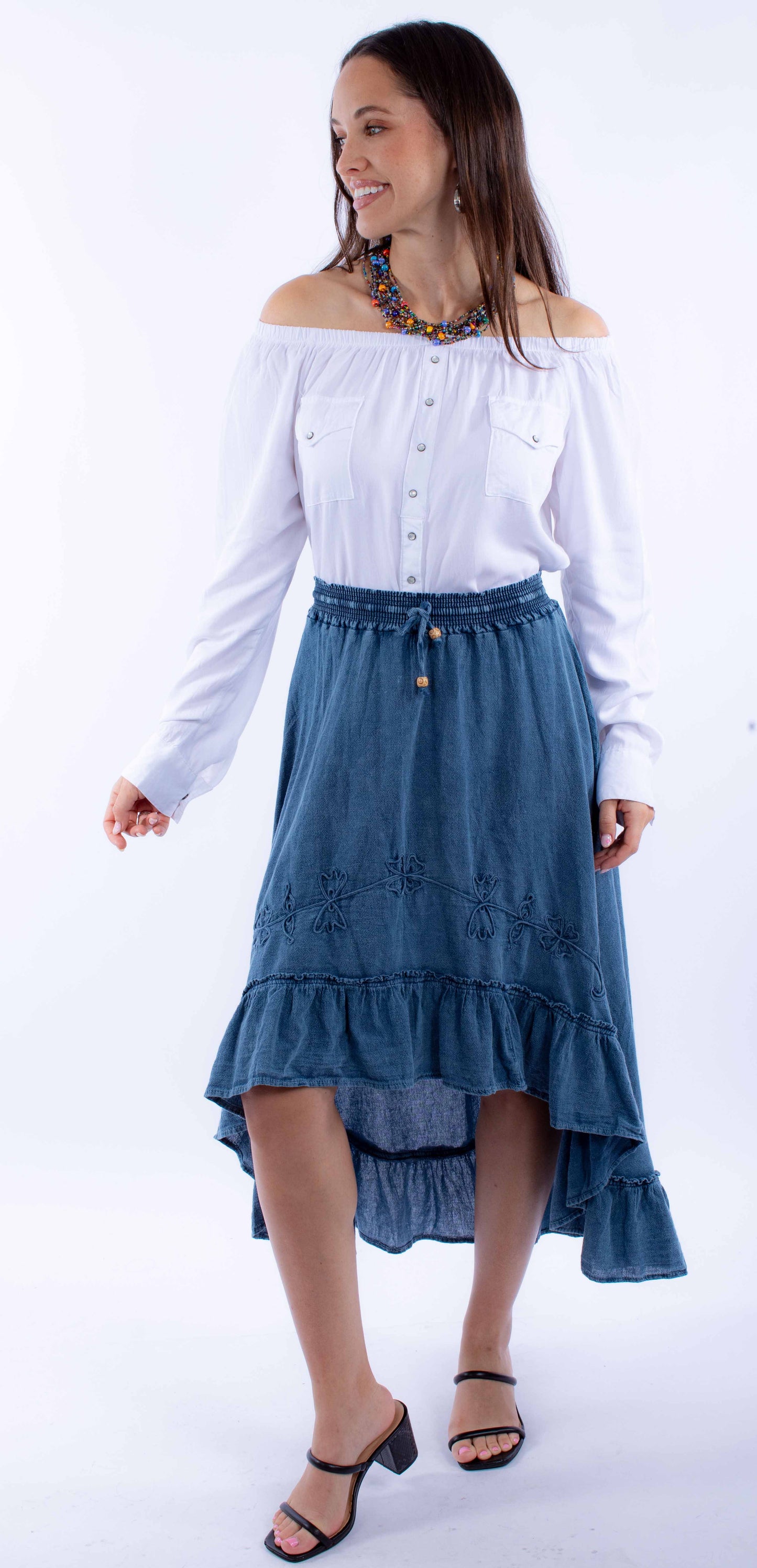 Woman in off-shoulder top & denim skirt