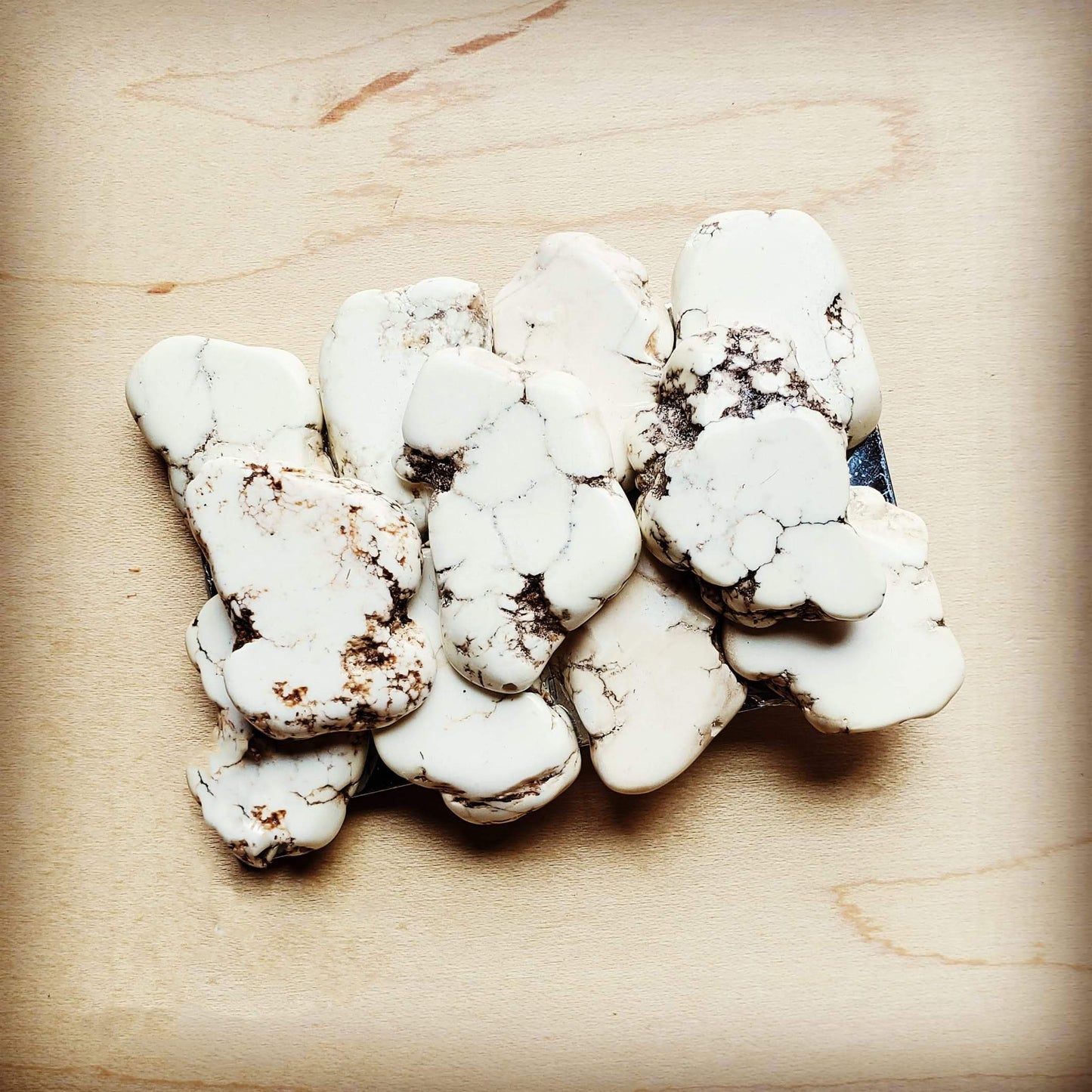 White and brown stone cluster on wood.