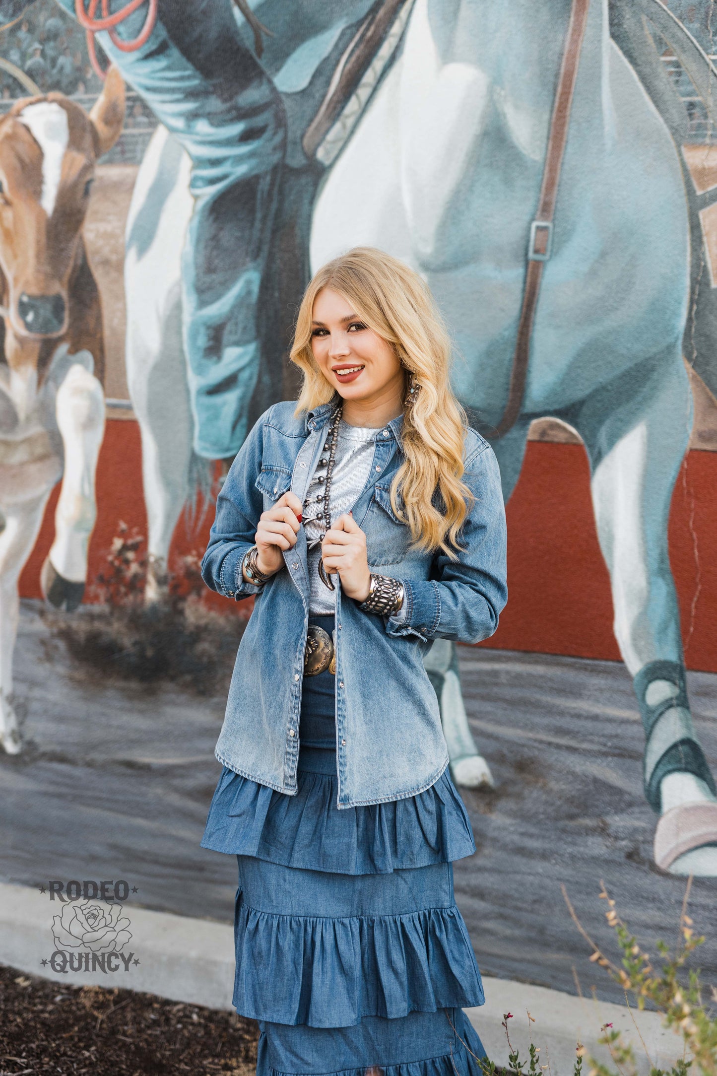 Denim skirt & jacket outfit against mural