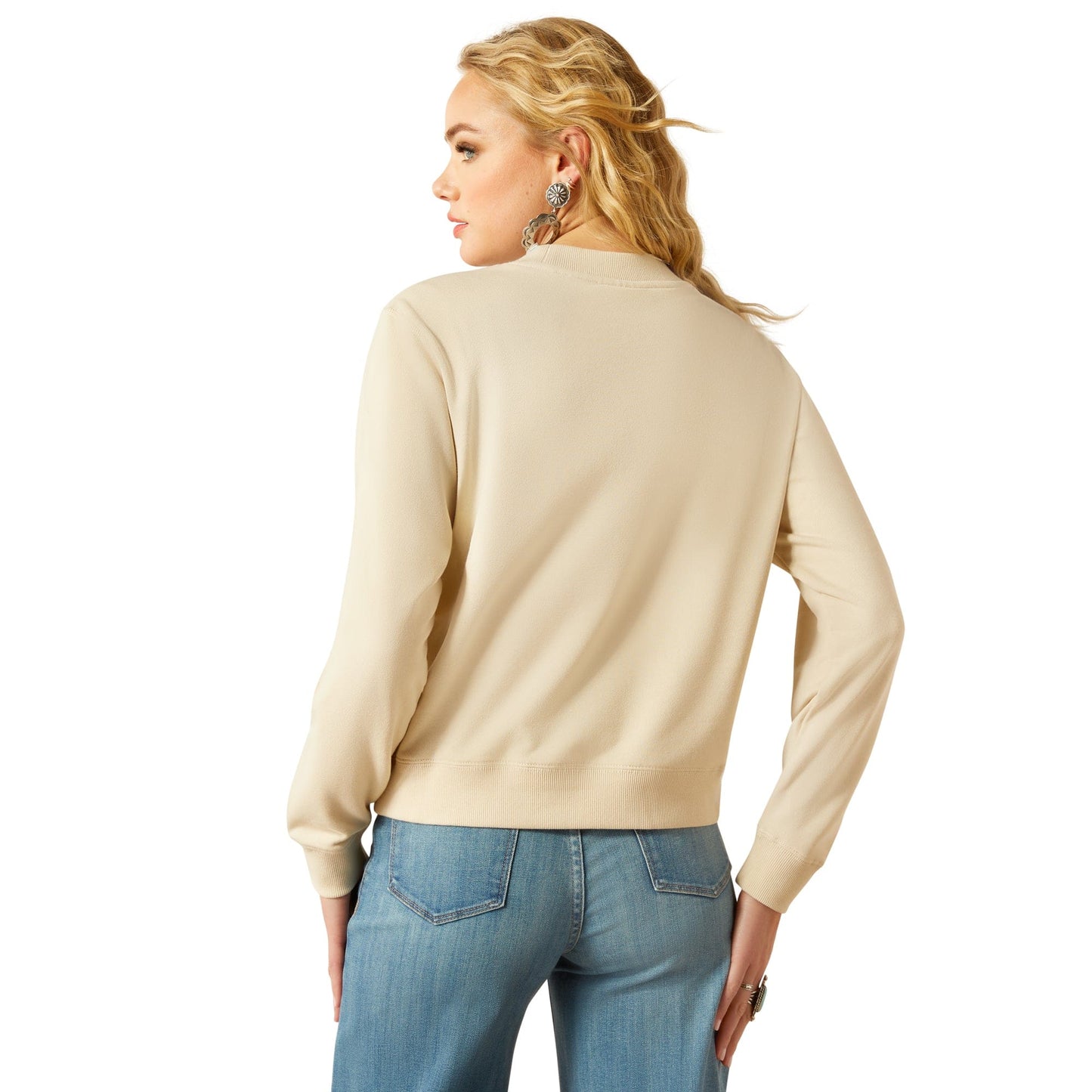 Woman wearing tan sweater, back view
