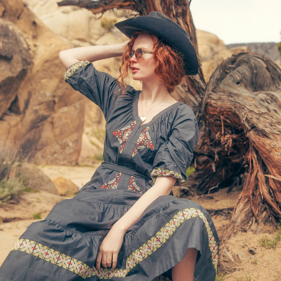 Mariana Dress in Onyx Gray with model in desert