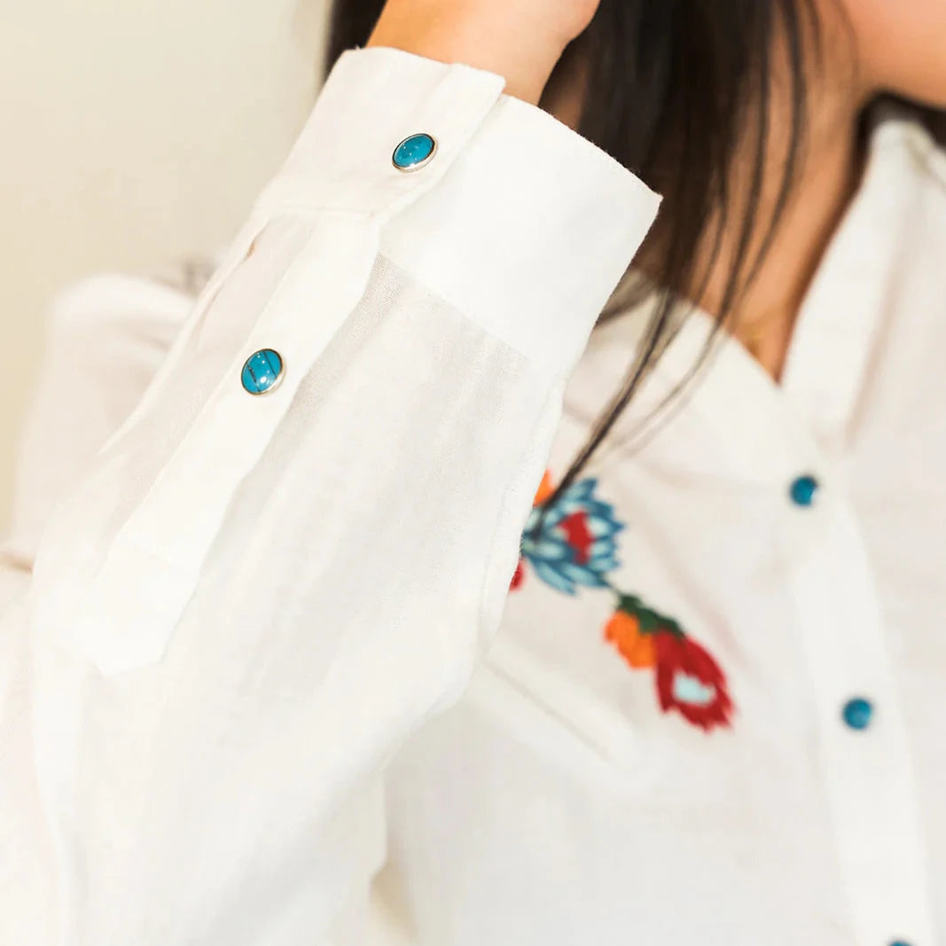 White shirt with turquoise buttons