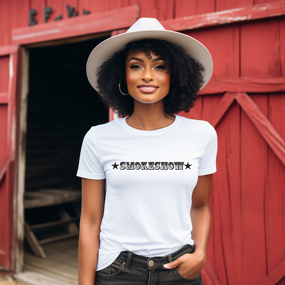 Woman wearing Smokeshow tee in front of red barn