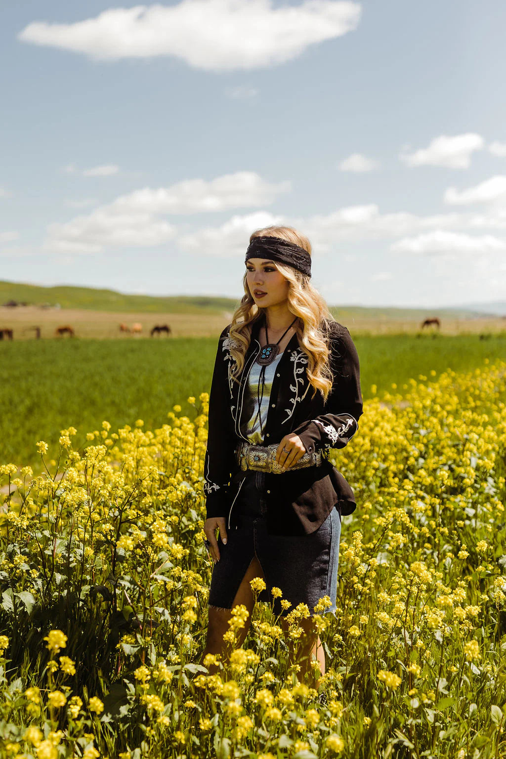 Woman in western wear in a field of wildflowers