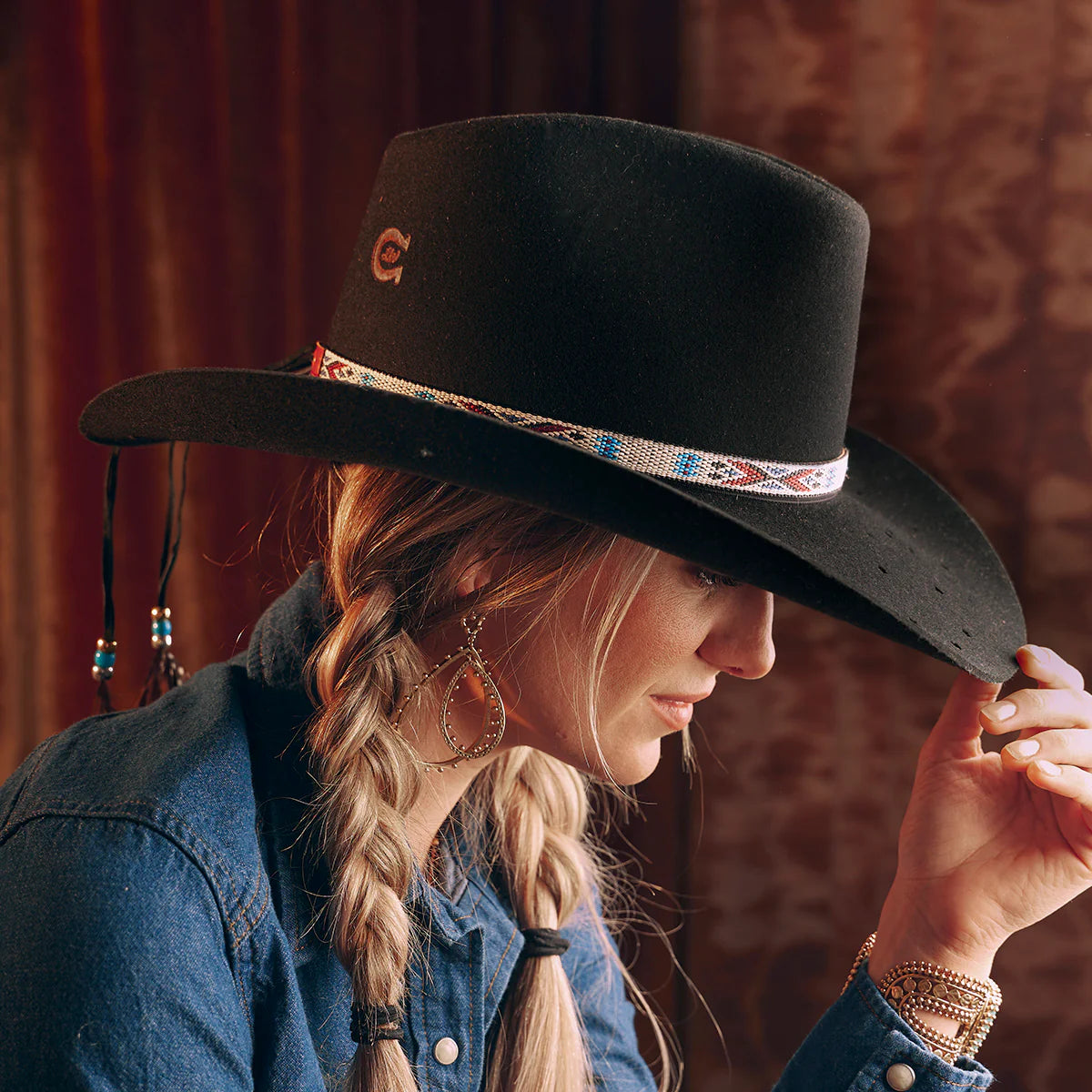 Woman in black cowboy hat, Wild Horse lifestyle