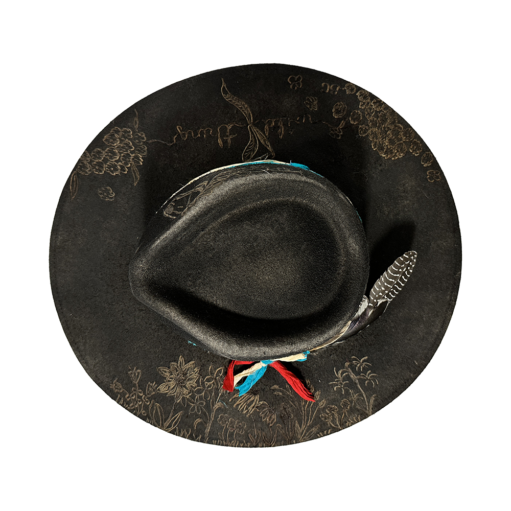 Black top hat with feather and floral design