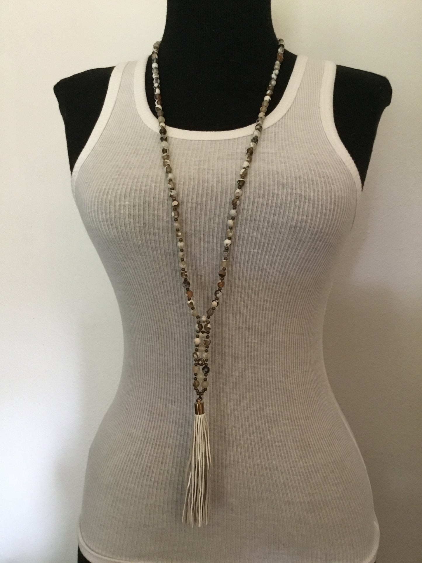 a359 beaded necklace on white tank top