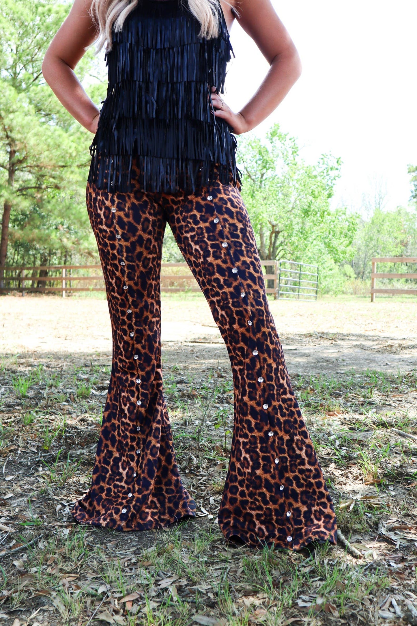 Woman in leopard print pants and black fringe top