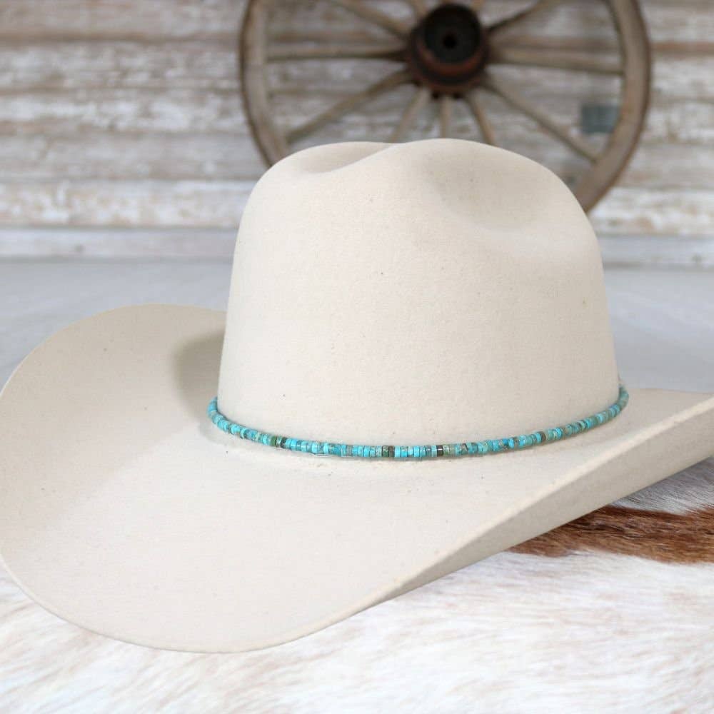 Cream-colored cowboy hat with turquoise beaded band.