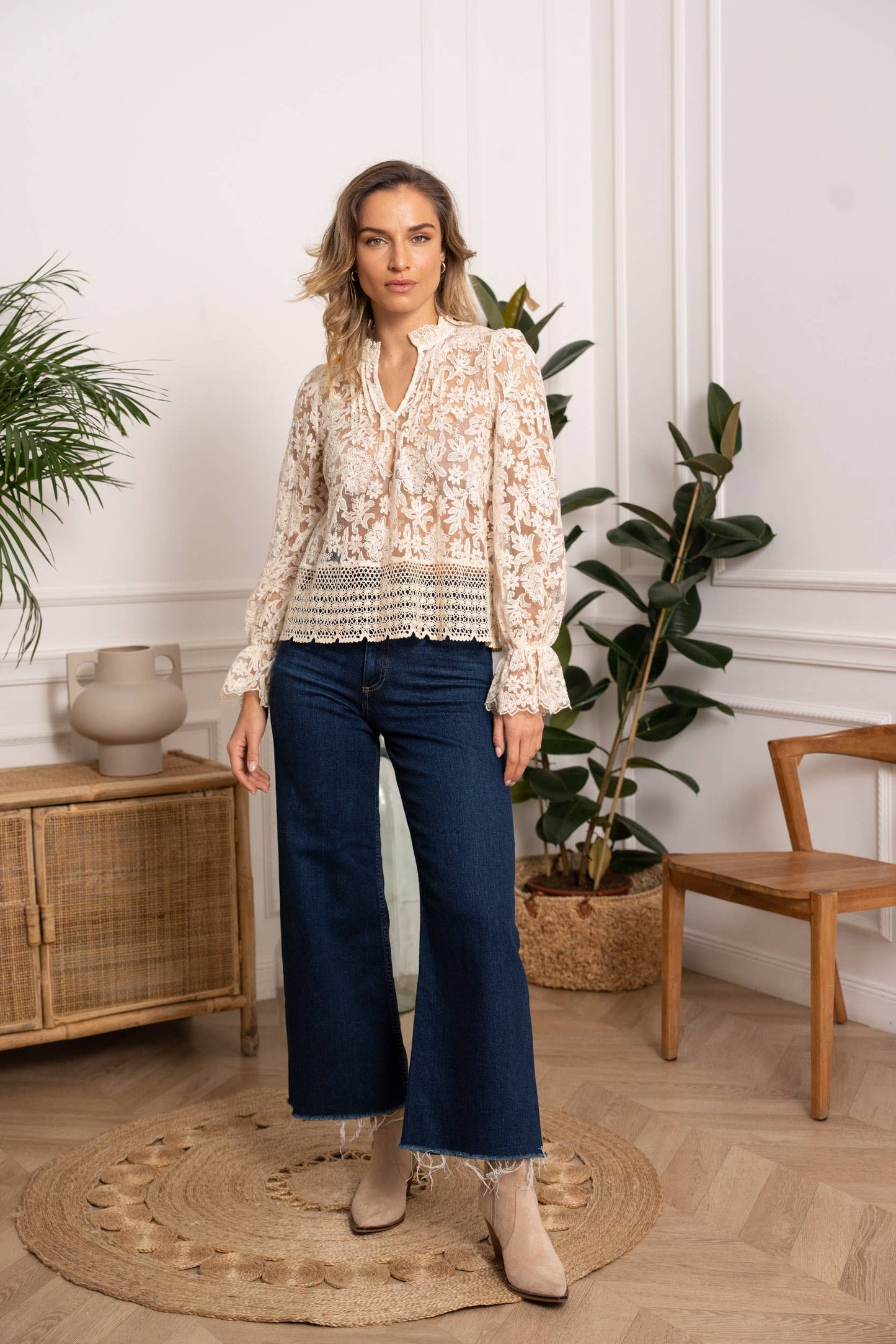 Woman in lace top and jeans.