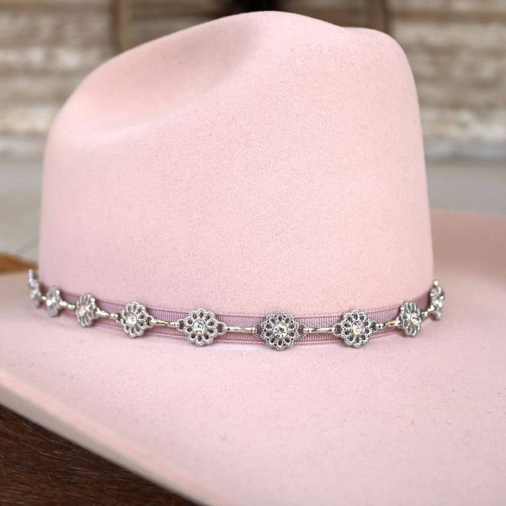 Pink cowboy hat with decorative band.