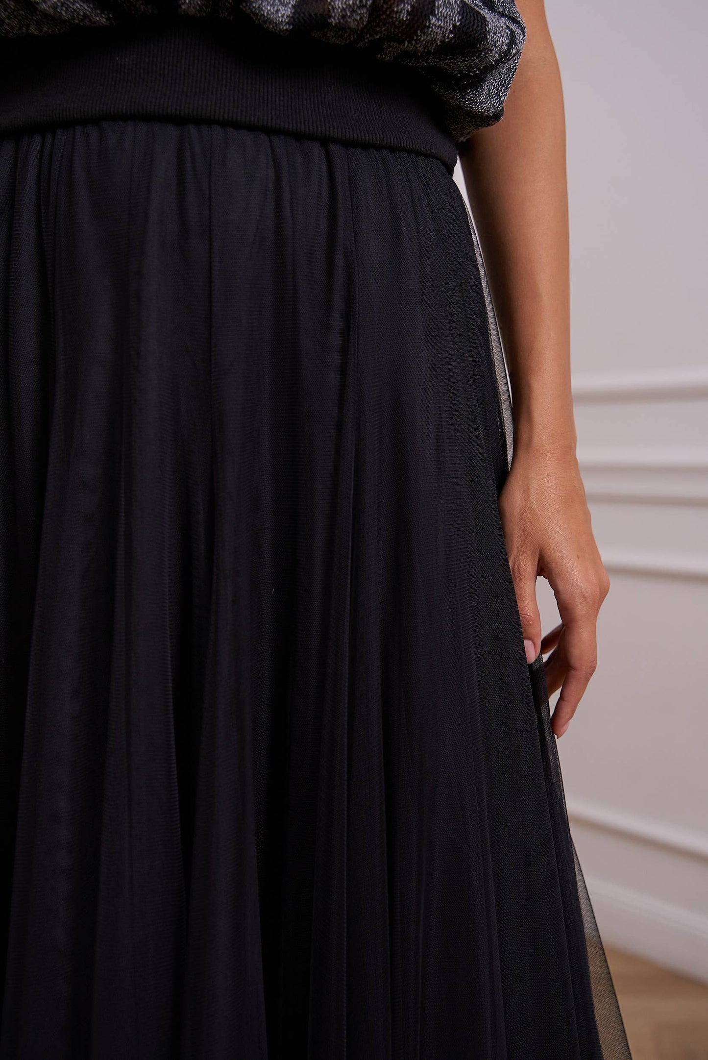 Woman in black tulle skirt.