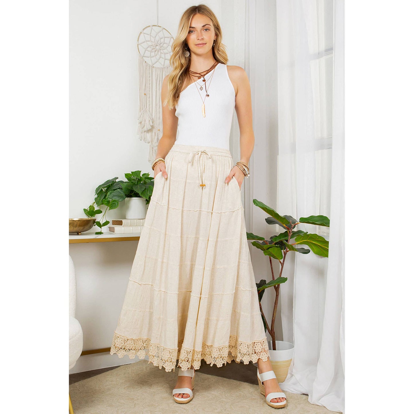 Woman wearing cream maxi skirt and white top