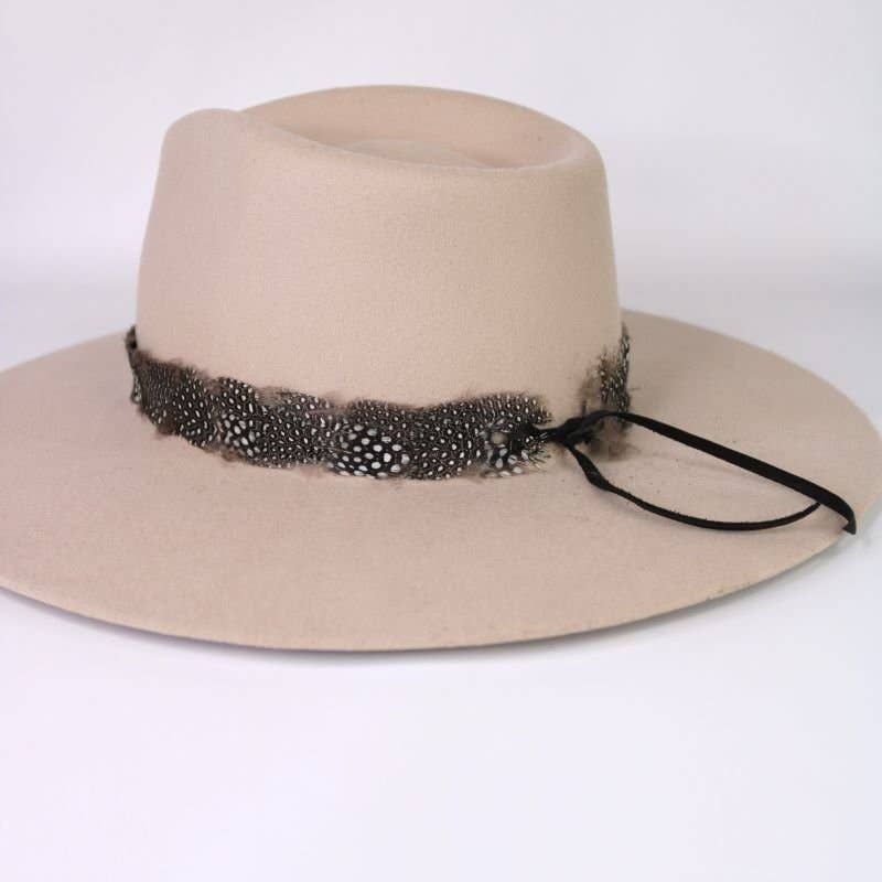 Beige hat with feather band.