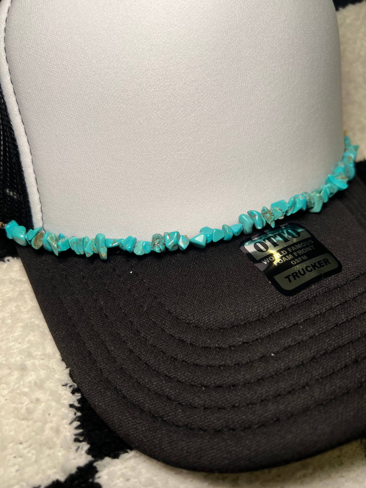 Black trucker hat with turquoise embellishment