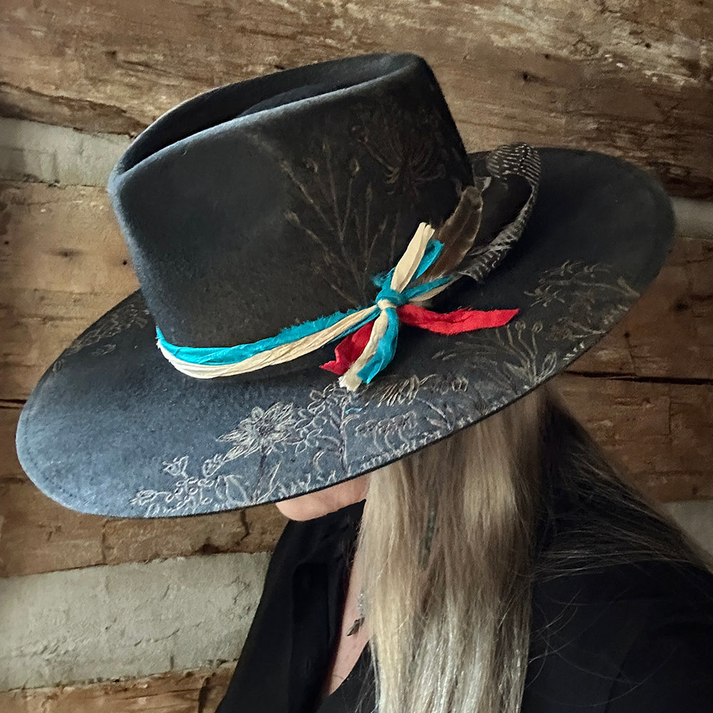 Black hat with floral detail and ribbon