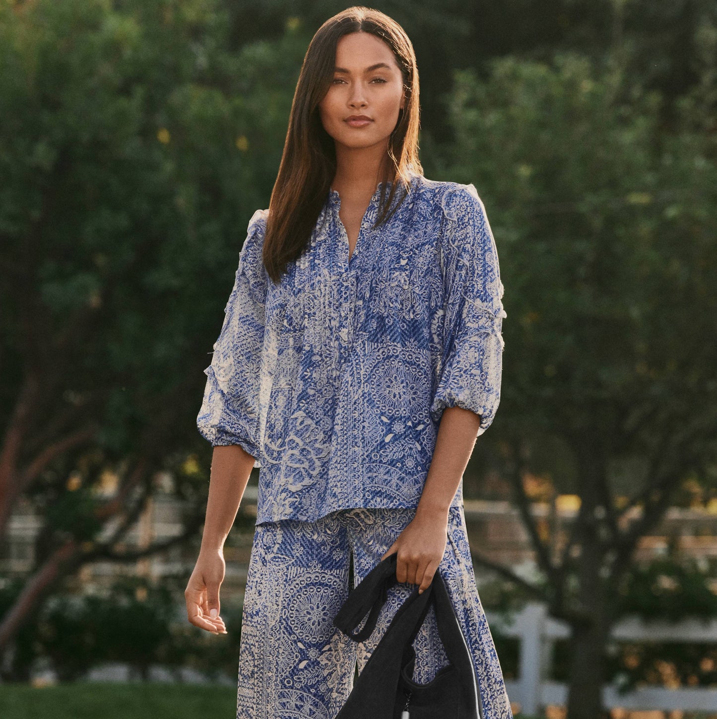 Woman in blue patterned top and pants