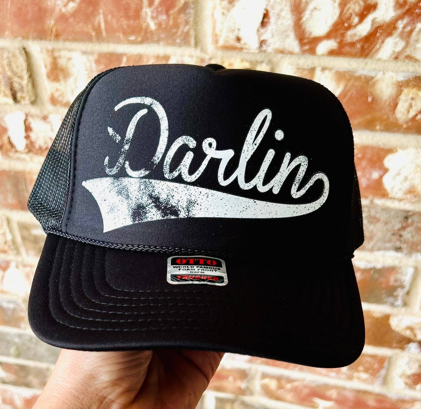 Black trucker hat with Darlin in white script.