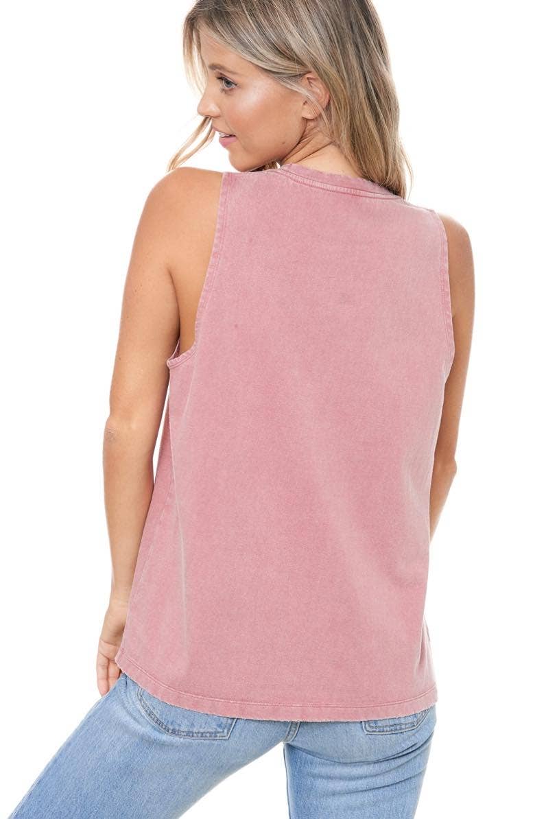 Woman in pink tank top and jeans.