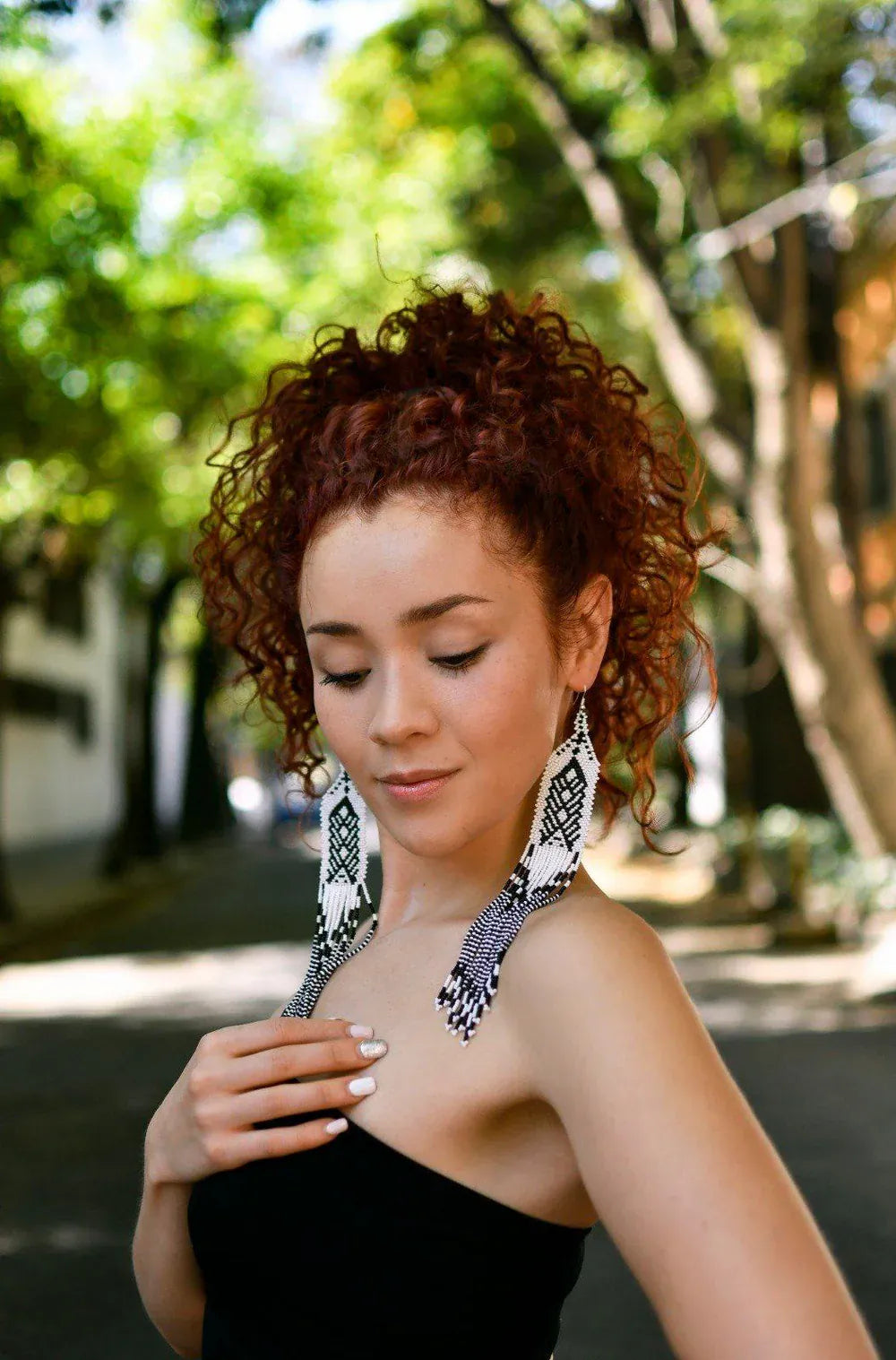 Woman wearing Cascadas earrings in Sierra