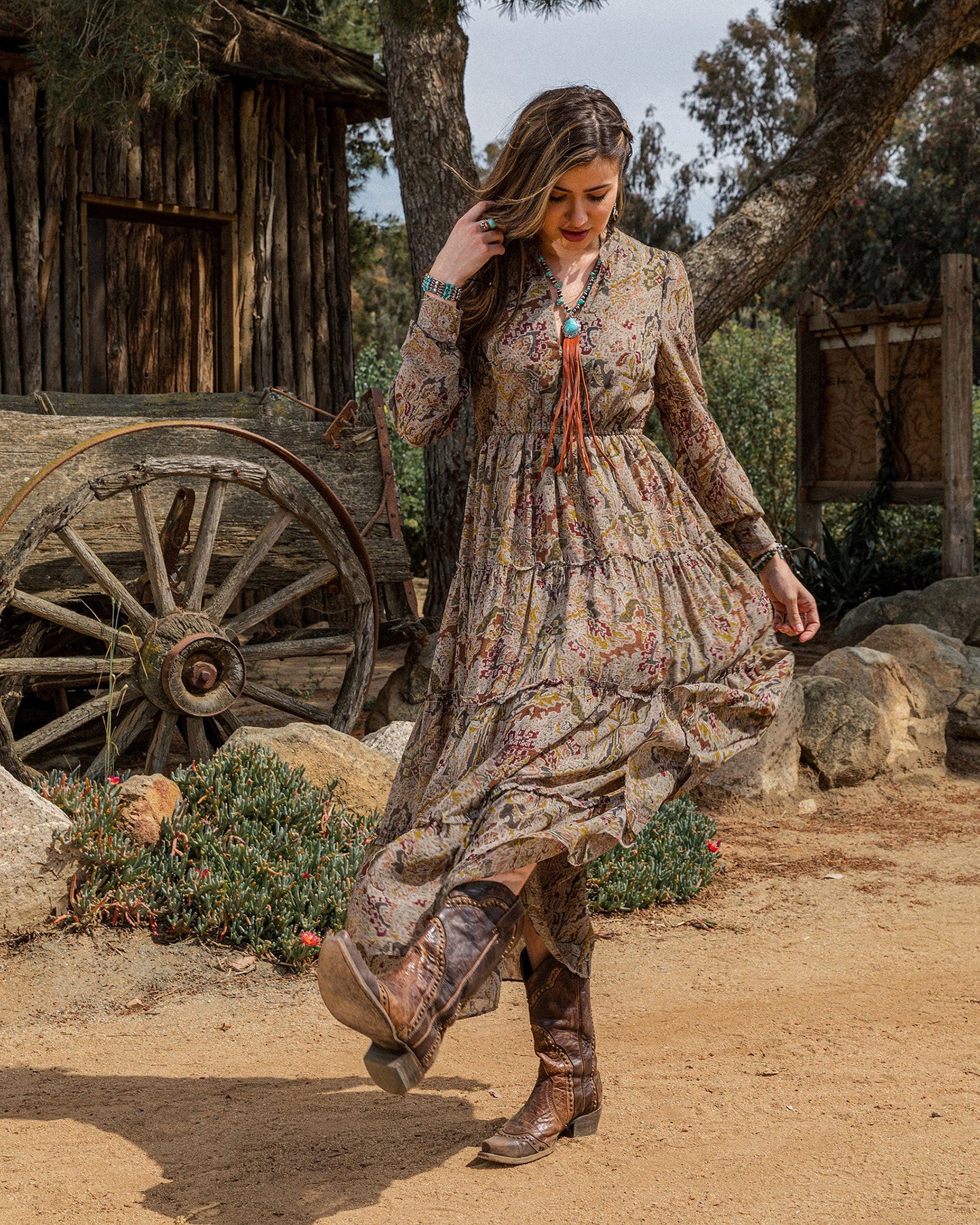 Woman in floral dress and cowboy boots, lifestyle photo