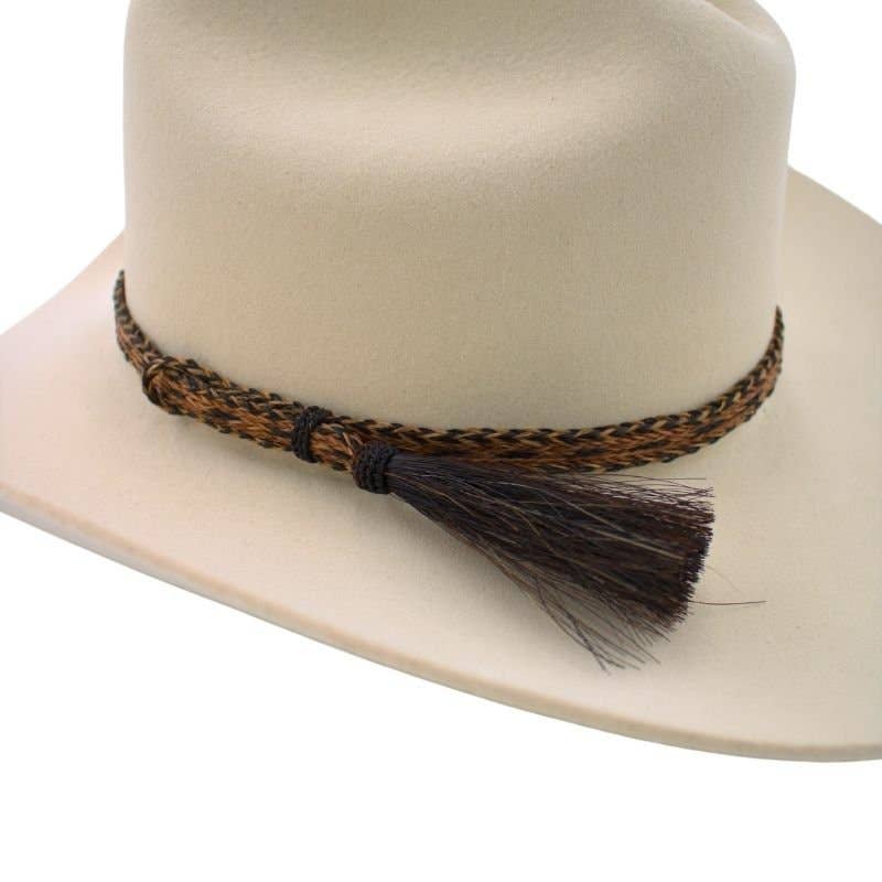 Cowboy hat with braided band and tassel.