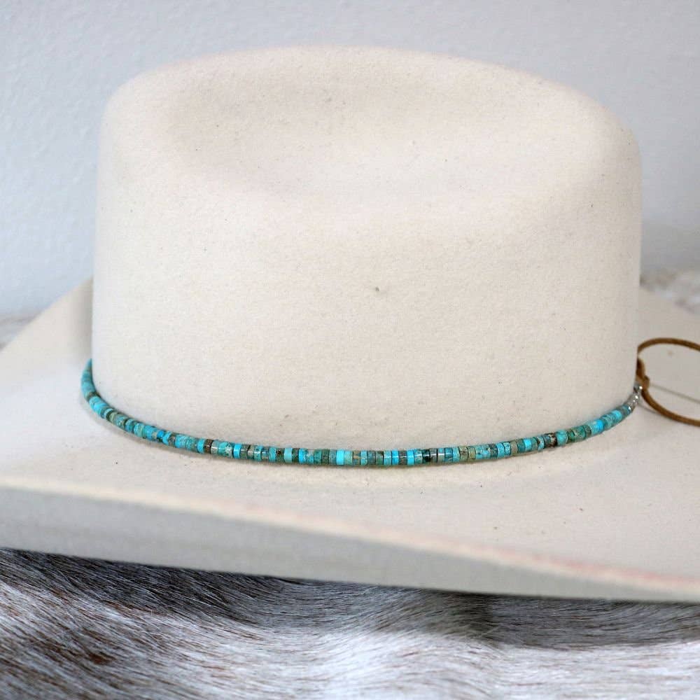 White hat with turquoise beaded hatband.