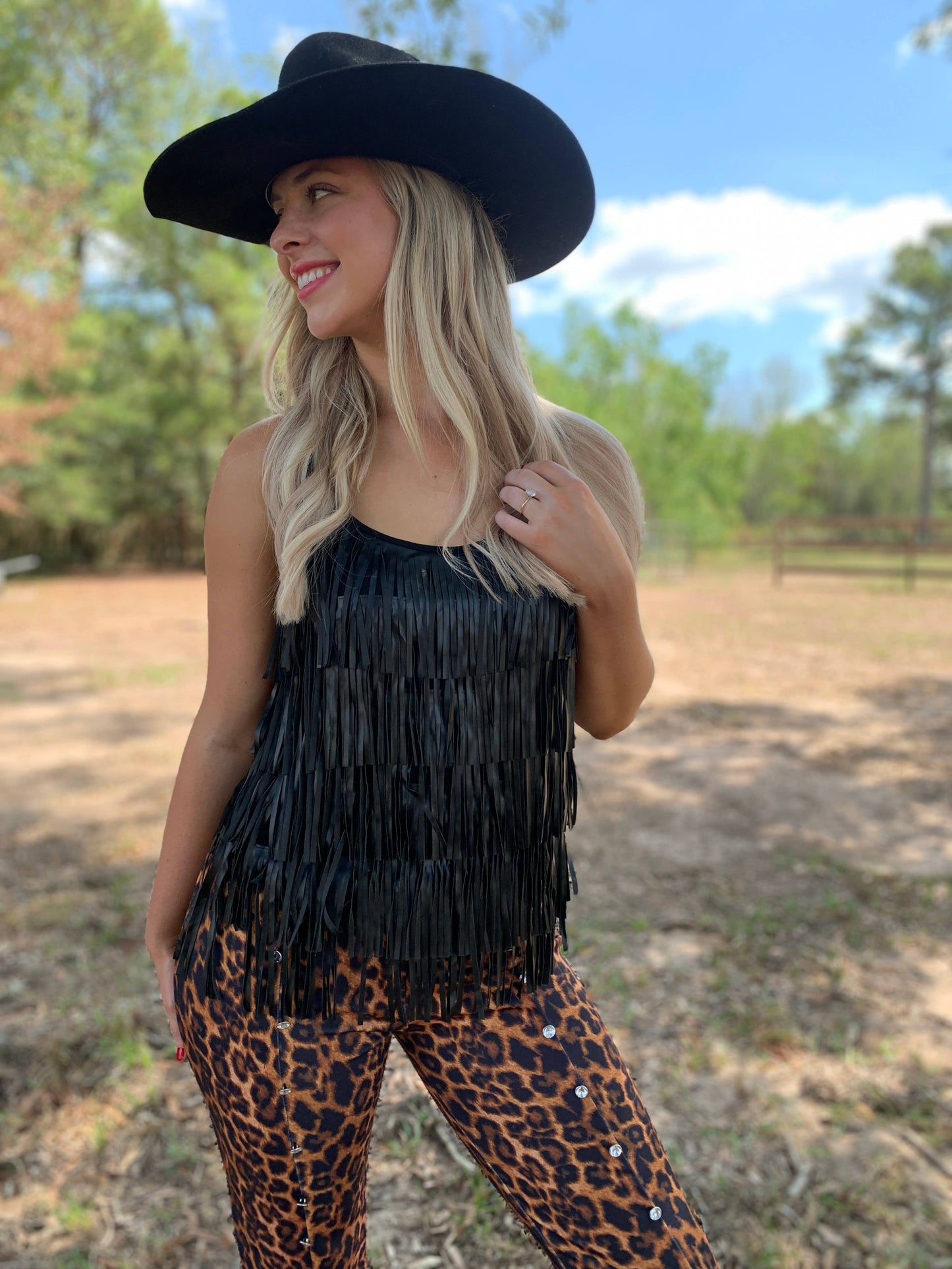 Woman in fringe top and cowboy hat
