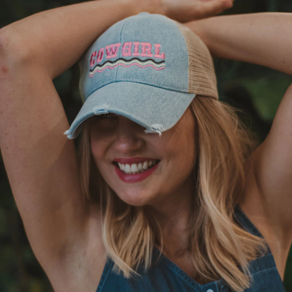 Woman wearing denim cowgirl hat