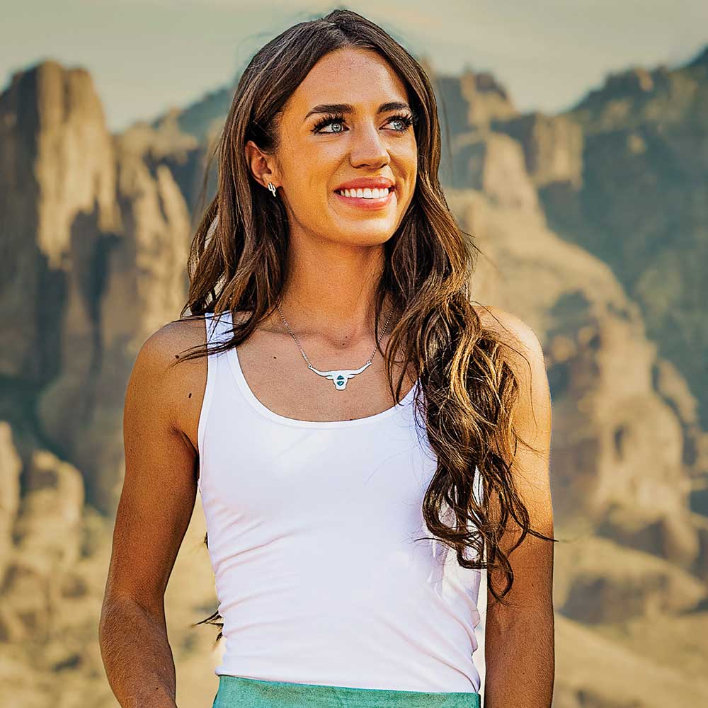 Woman in white tank top smiling, NC5765