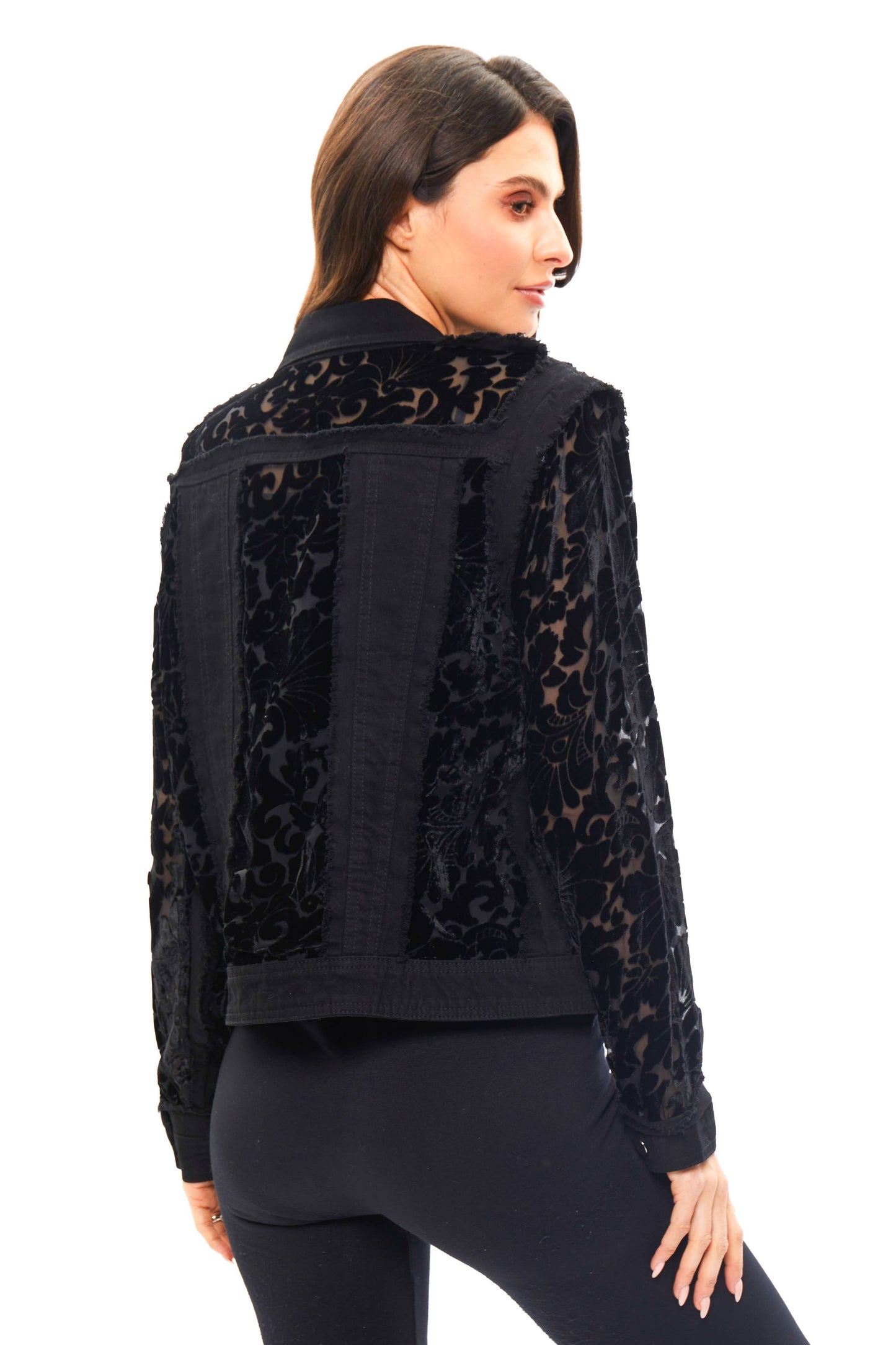 Woman wearing a black floral-patterned jacket.